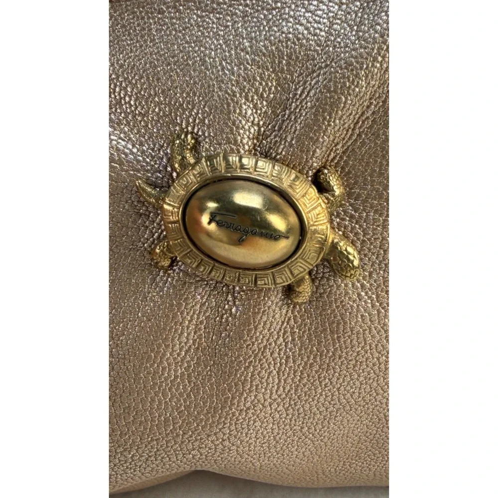 Auth Salvatore Ferragamo Gold Turtle clasp Metallic leather clutch w/dustbag